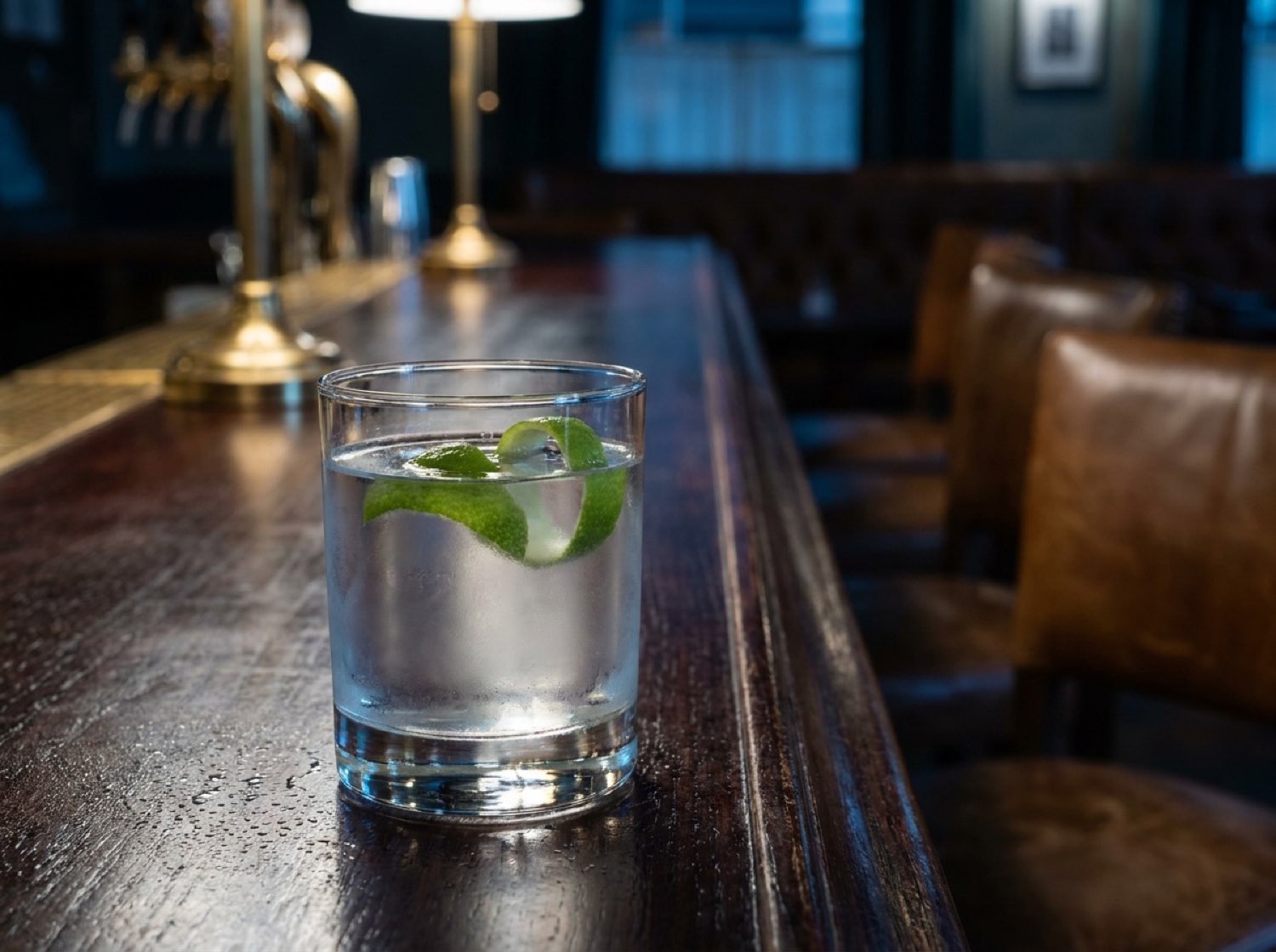 PartyQueueCrew suite lounge area — dark bar top, green citrus detail